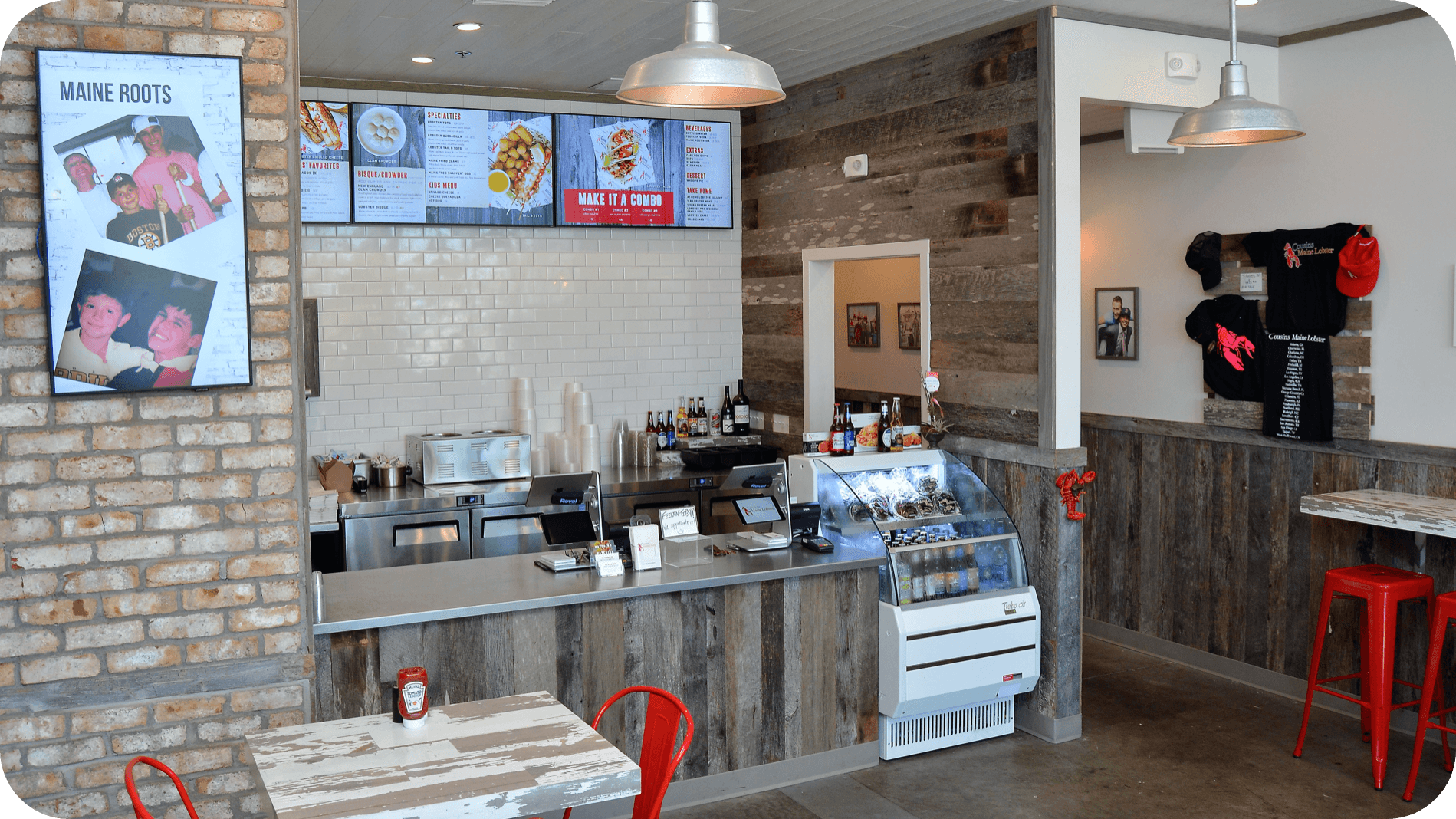 An image of the interior of our Neptune Beach restaurant showing the front of house area with digital signage and ordering counter.