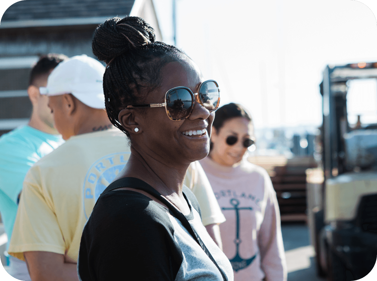 An image of some of our Cousins Maine Lobster family members smiling on a wharf in Portland, Maine.