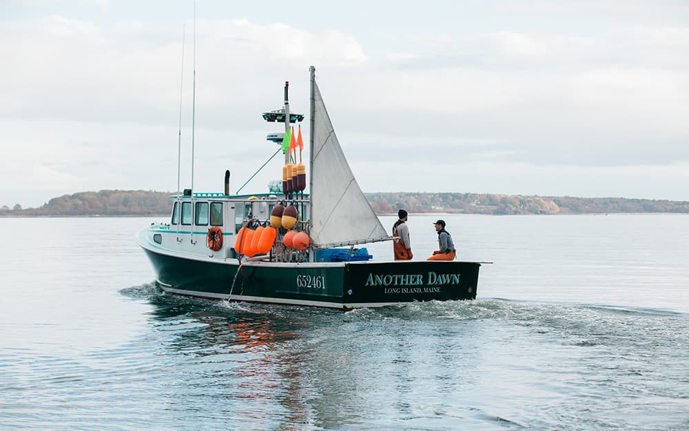 A picturesque photo of a Lobster Boat in Maine, on very calm water.