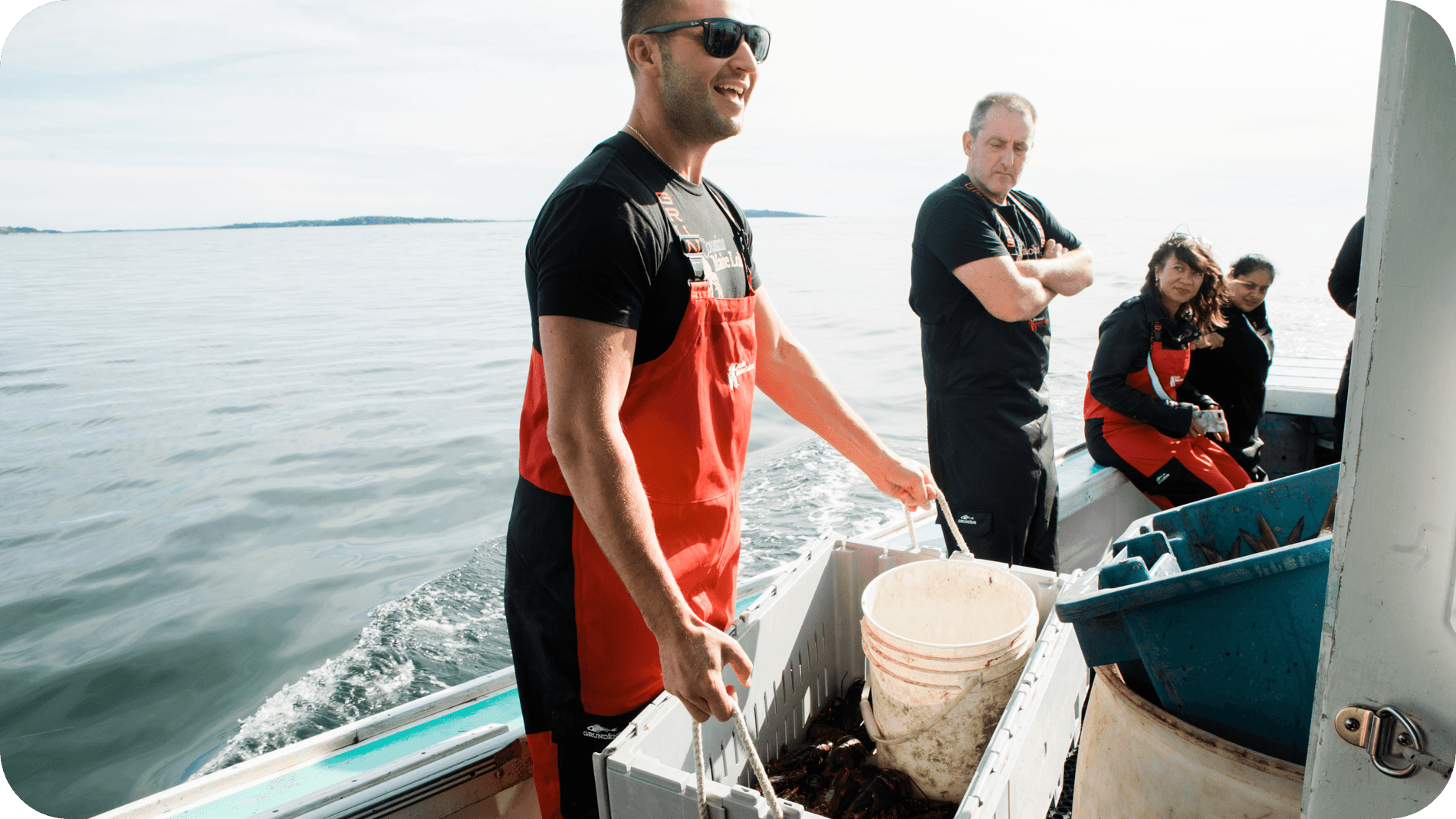 An image of Cousin Jim on board a lobster boat, moving a crate of lobsters.